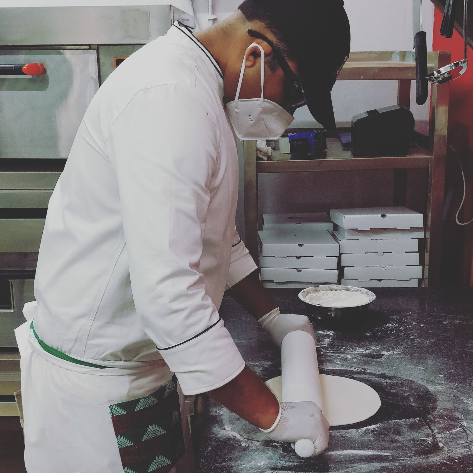 Chef Roy rolling fresh pizza dough daily